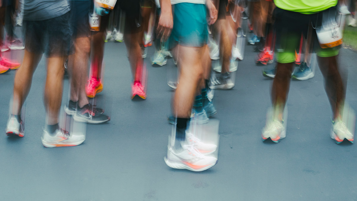 Image Of A Group Of Marathon Runners' Feet Blurred Emoting The Problem Of Sleeping After A Marathon