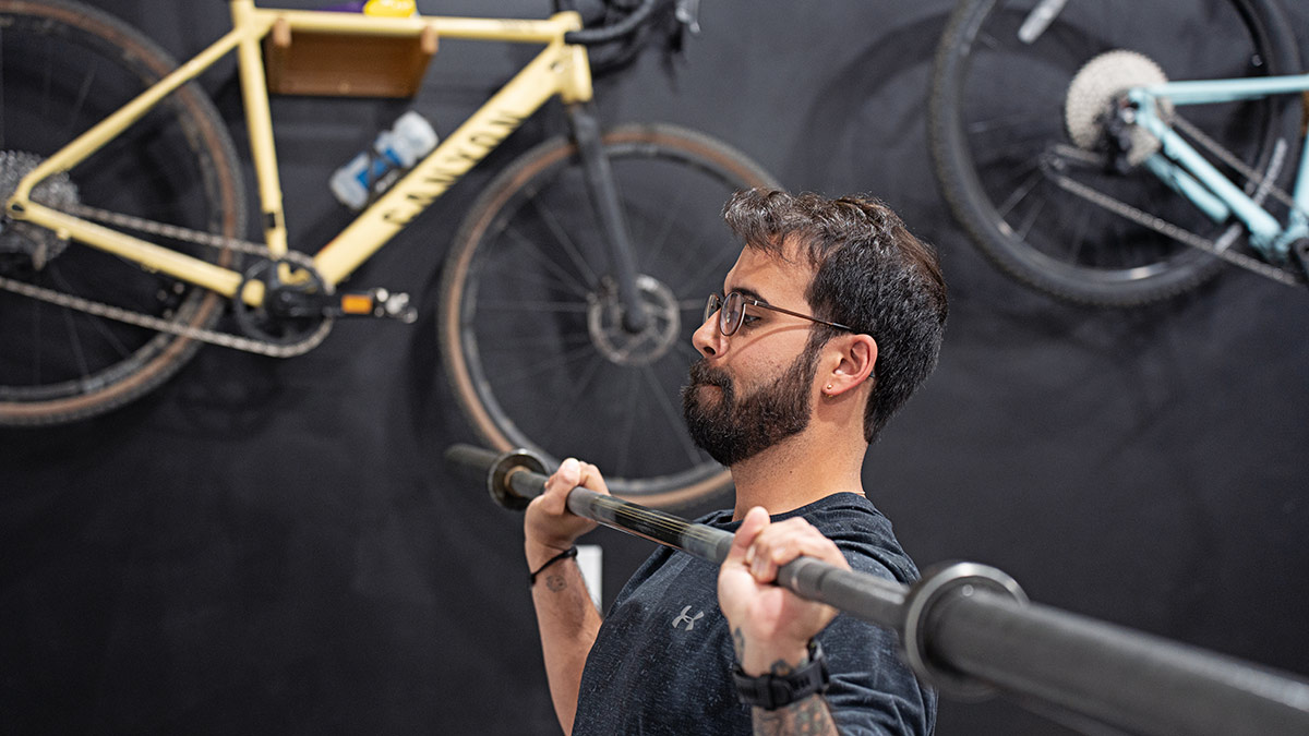 Strength Guide Chapter 5 Male Cyclist Doing Barbell Overhead Press For Strength Training