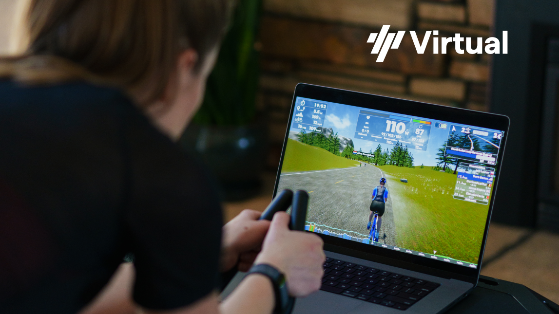 Trainingpeaks Virtual Block Female Cyclist Riding Indoor Trainer In Front Of Laptop With Trainingpeaks Virtual